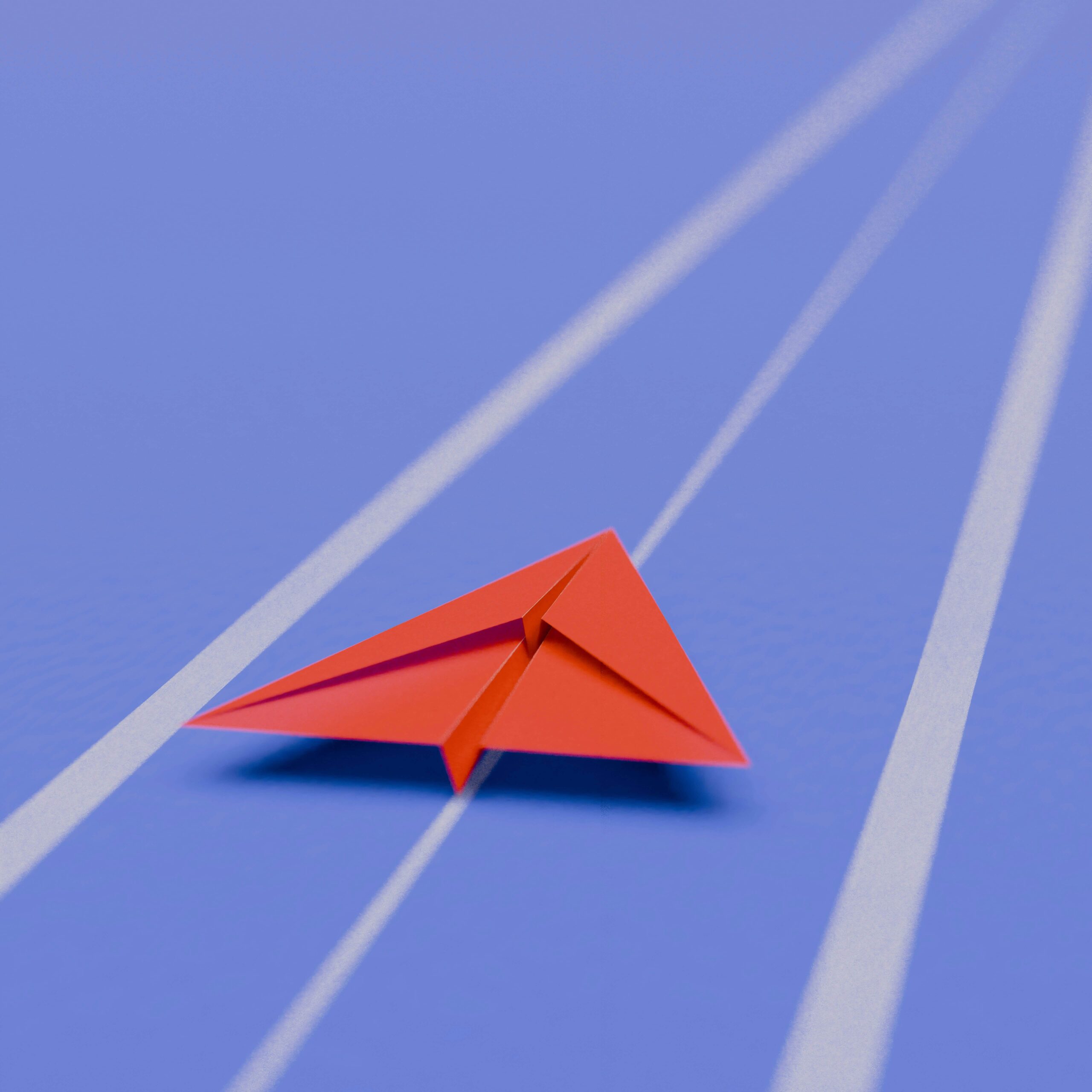 Services A red paper airplane on a blue surface with white lines, symbolizing Business Development plan.